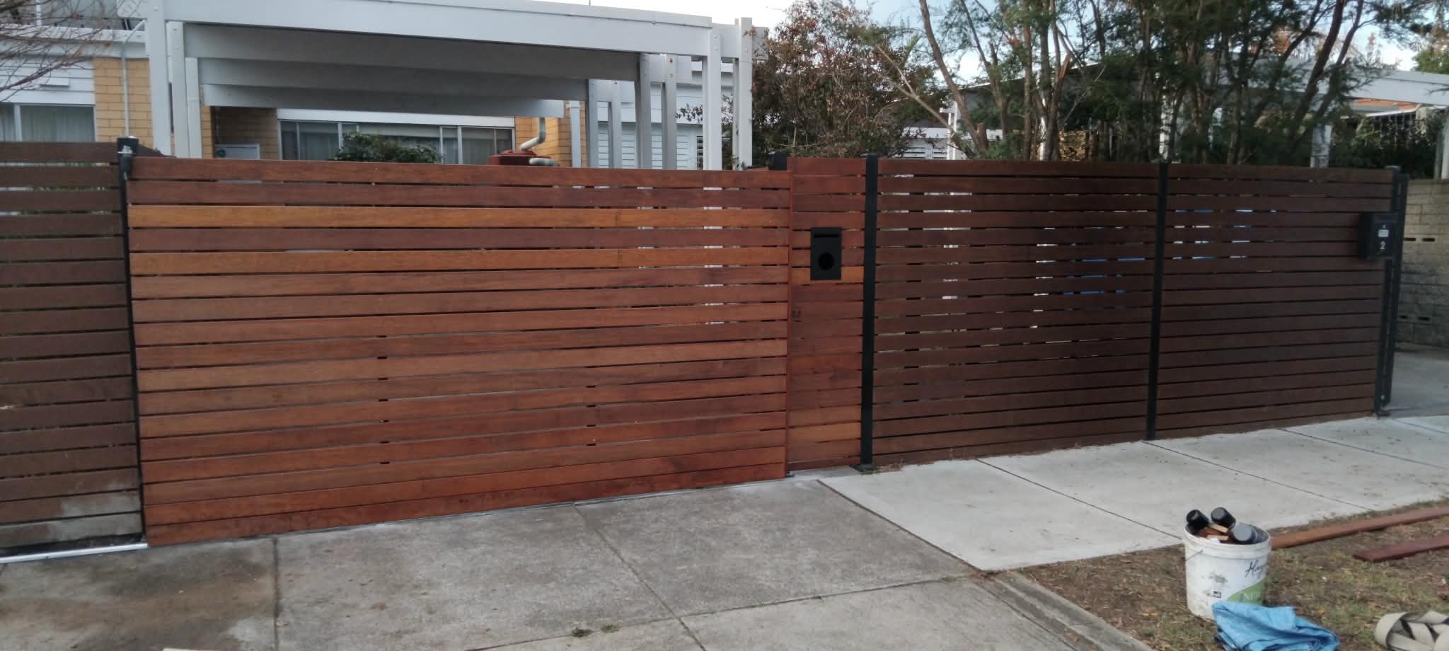 Merbau front fence with automatic gate by Mordy Fencing