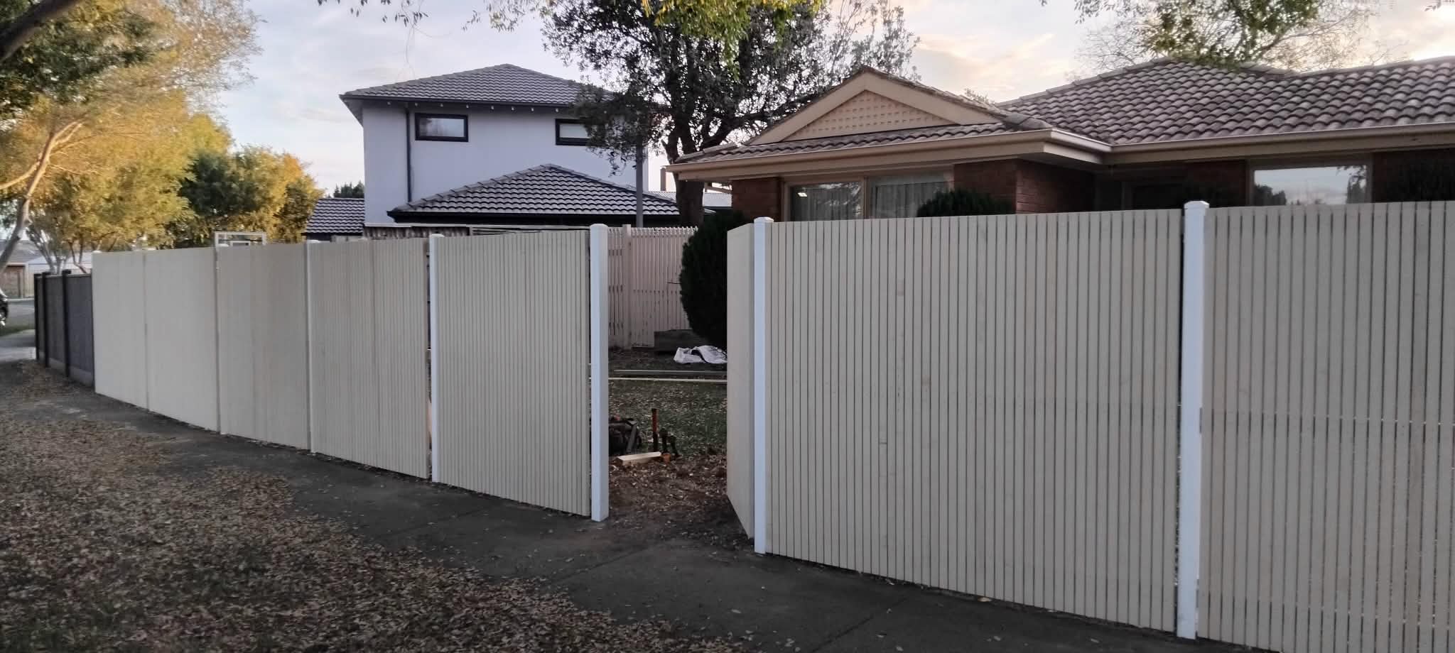 Primed laminated picket front fence with pedestrian gate by Mordy Fencing